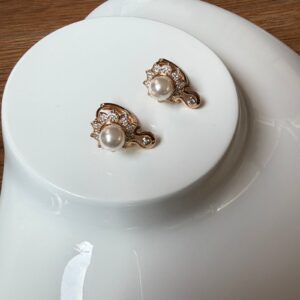 A18692 ARETE TIPO FLOR CON PIEDRAS Y PERLA ENMEDIO 18K